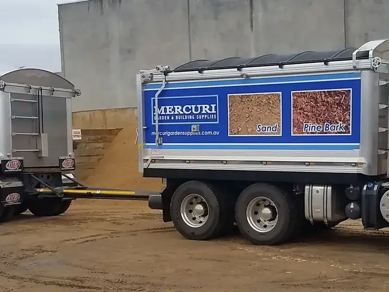 Mercuri Garden & Building Supplies truck and trailer loaded with building materials