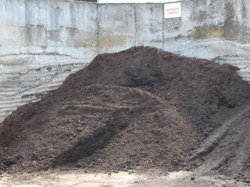 Bulk soil and garden materials stacked in concrete bays at the Bundoora yard