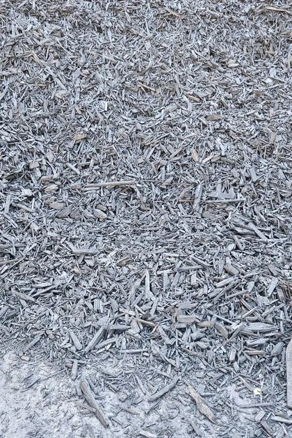 Black mulch piled in a concrete bay at the Bundoora yard